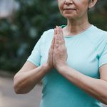 A woman holds her hands together