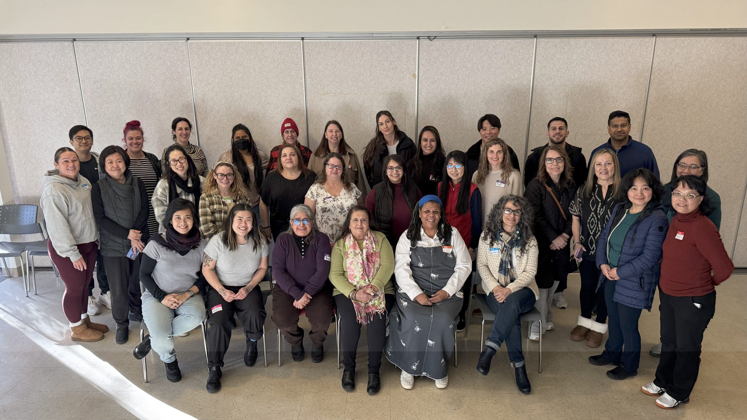 A large group of staff from CNH pose for a photo indoors