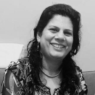 A black and white photo of a woman with dark hair smiling into the camera