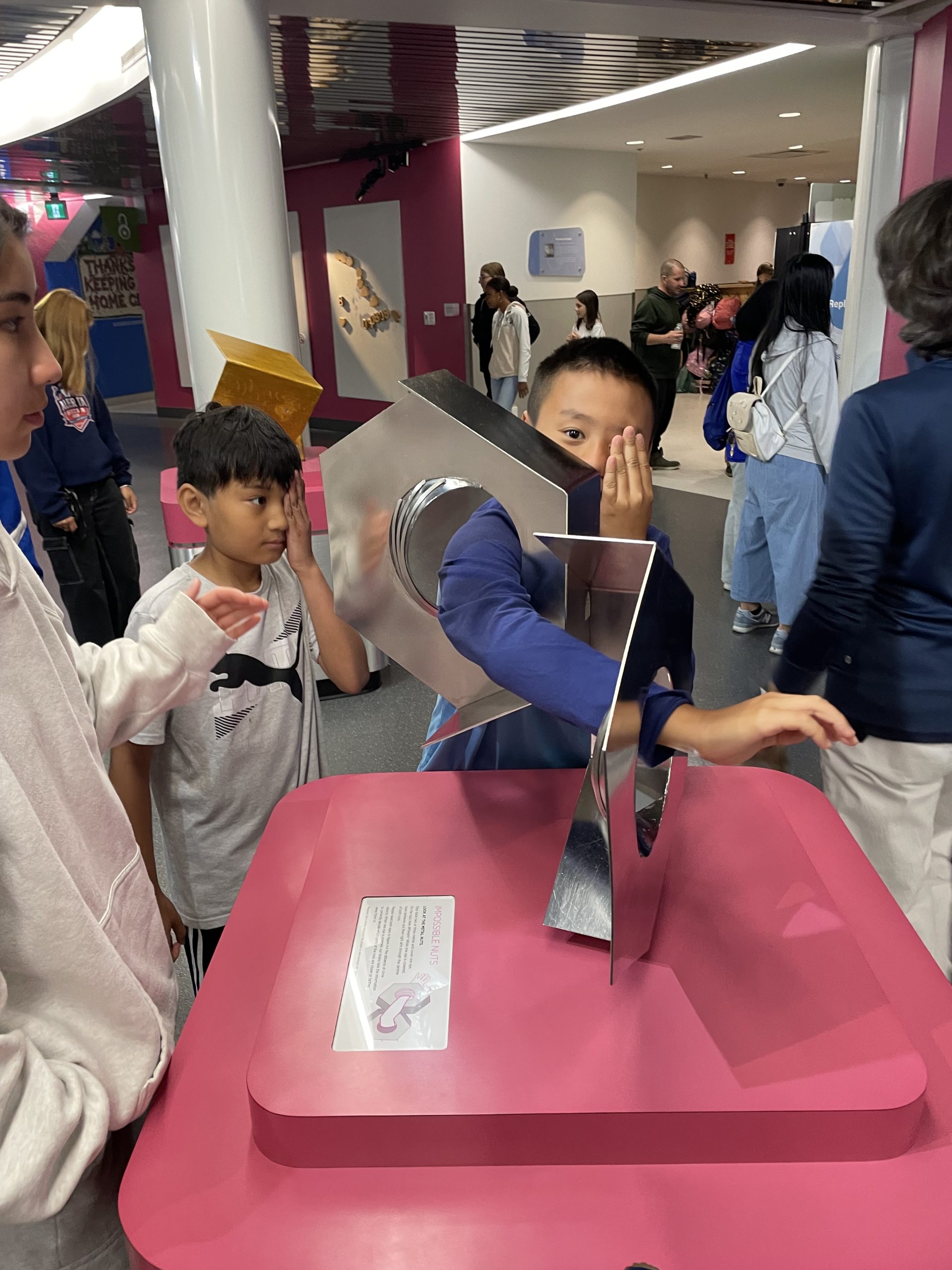 A child puts their arm into an interactive display at a science centre