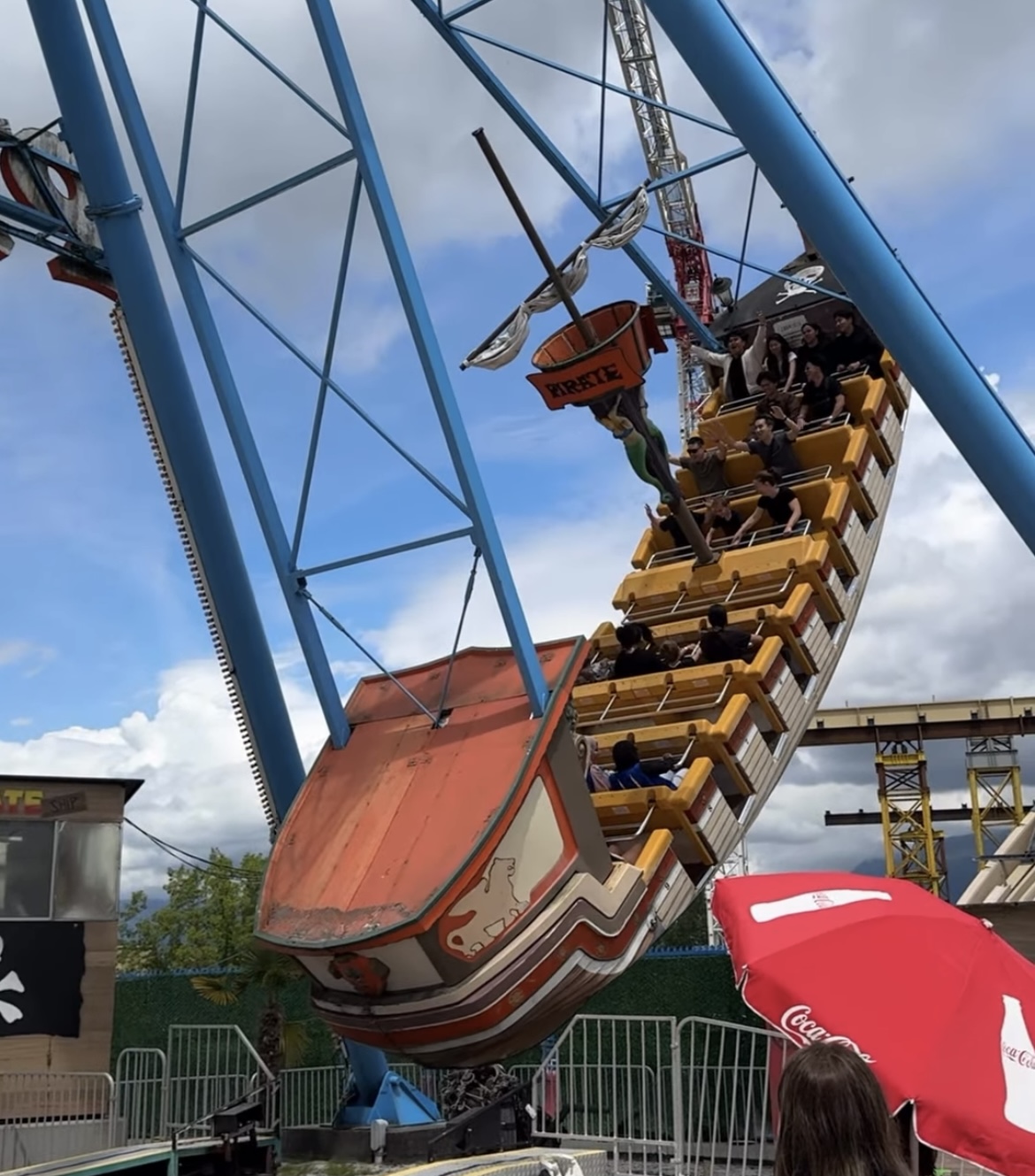 A pirate ship ride at an amusement park swings in the air